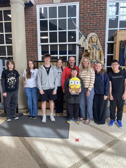 Groups of students standing with a Minon