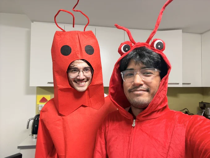 two founders in red lobster costumes smiling at the camera just before their YC interview