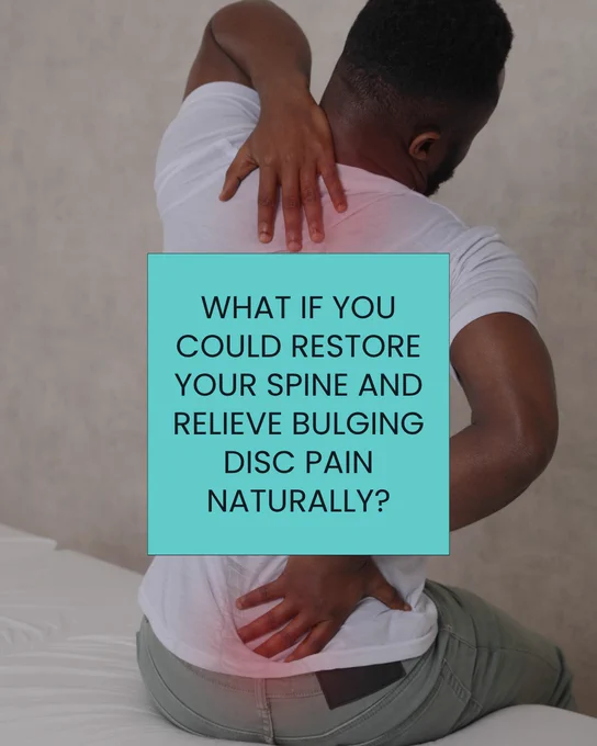 A man touching his back due to bulging disc pain.