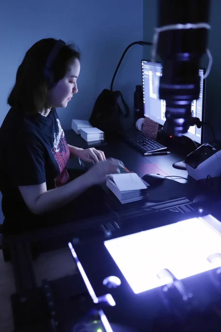 Maeve Iwasaki demonstrates microfiche digitization. Photo by Brad Shirakawa, October 21, 2025.