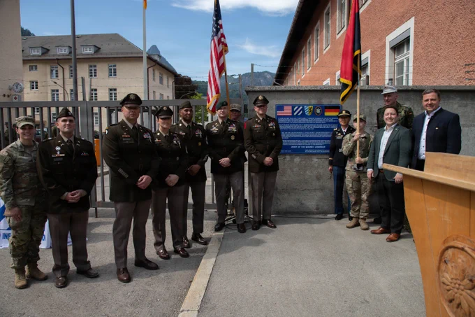U.S. and German Soldiers and leaders pose with American flags at a Bad Reichenhall site during the liberation anniversayr observance.