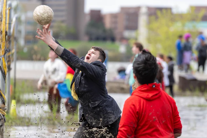 An Oozefest player jumps for a ball while wearing a full suit.