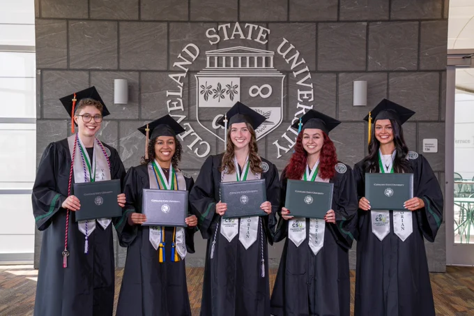 Spring 2026 Valedictorians wearing academic regalia and posing in front of CSU seal with diplomas. Pictured left to right are Grace Moon, Leilah Flores, Sarah McCartney, Vivian France, and Sydney Wisnor