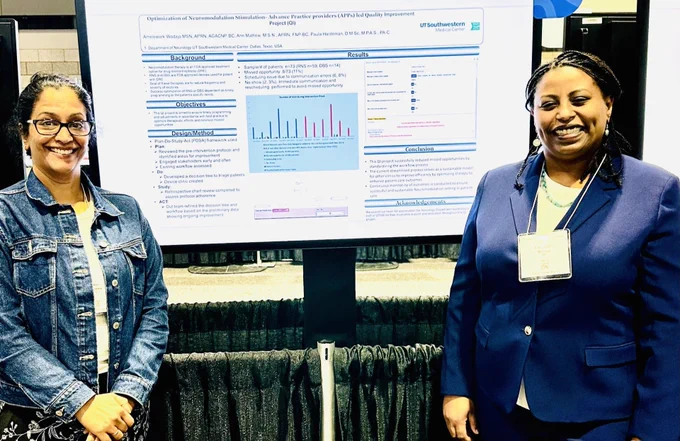  Ann Mathew, M.S.N., APRN, FNP-BC & Mimi Wodajo M.S.N., APRN, CCRN, AGACNP-BC, QIA with their poster