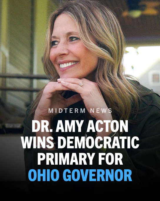 A graphic featuring a photo of a smiling Dr. Amy Acton with her hands resting under her chin. Bold white and blue text overlaid reads: "Midterm news: Dr. Amy Acton wins Democratic primary for Ohio governor."