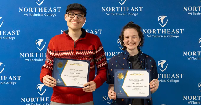 Two people smiling and holding certificates in front of a Northeast WI Technical College backdrop.