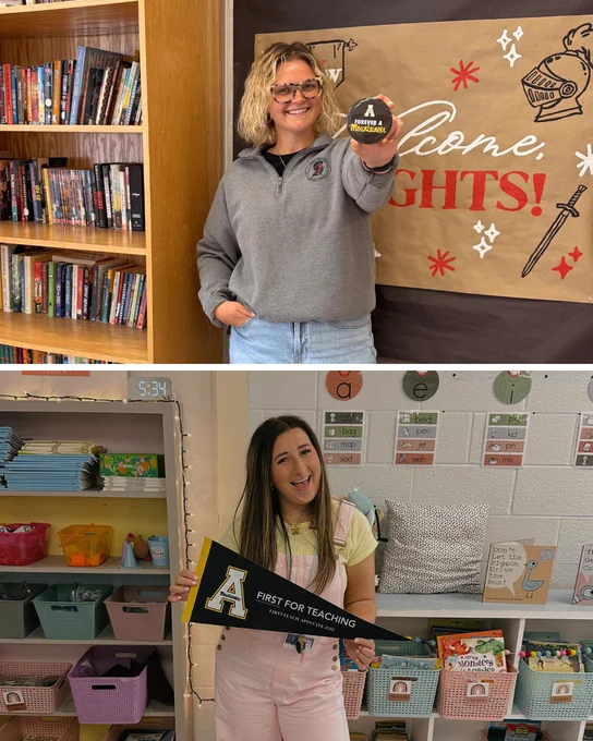 Bailey Brown ’22 and Madison Osborne ’21 smile in a classroom setting, holding an App State “Forever a Mountaineer” button and a “First for Teaching” pennant.