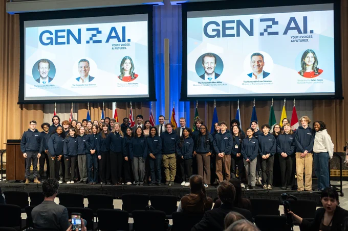 Gen(Z)AI participants, youth fellows, and project leads posing for a group photo with the Honourable Evan Solomon (Minister of AI and Digital Innovation) and the Honourable Marc Miller (Minister of Canadian Identity and Culture). Photo by Lindsay Ralph.