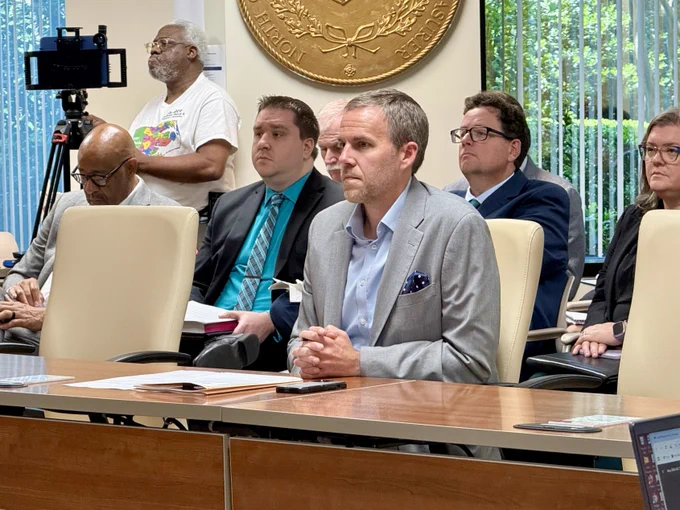 City of Charlotte N.C.  sitting at a conference table during the Local Government Commission Meeting. 