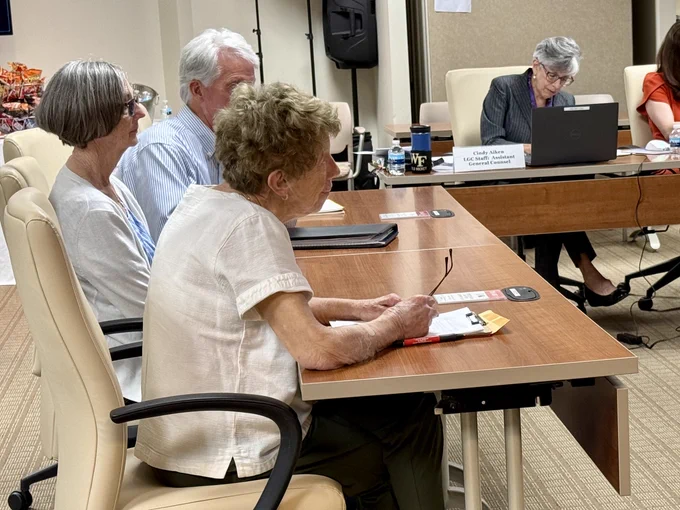 Littleton N.C representatives sitting at a conference table during the Local Government Commission Meeting. 