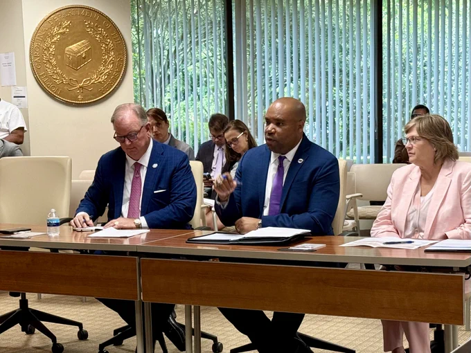 Mayor of Rocky Mount N.C. and representatives sitting at a conference table during the Local Government Commission Meeting.  