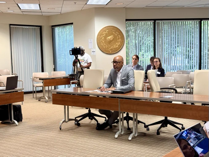 A representative from Speed, N.C.  sitting at a conference table during the Local Government Commission Meeting. 
