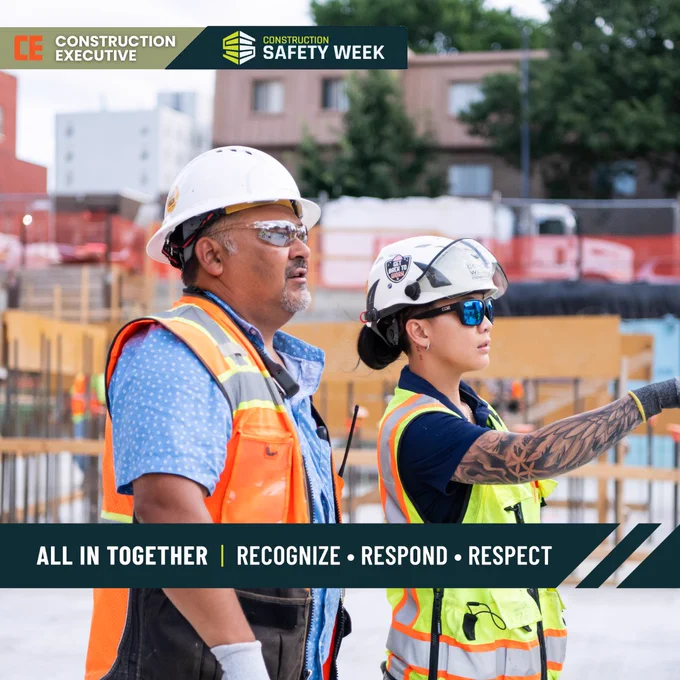 A female construction worker and a male construction worker in safety gear, looking at a construction site.