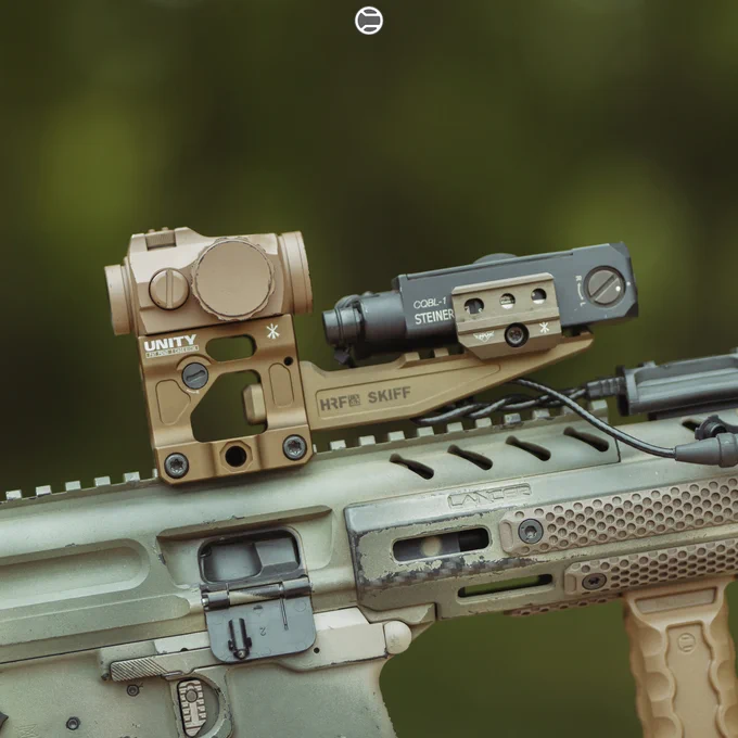 RailScales QTR Stop, RSBM-P Polymer M-LOK VFG, G10 RailScales M-LOK Scales (MiniDot, TerraCore, 3-Slot), G10 Solo's M-LOK Scales (MiniDot, TerraCore, 1-Slot), QDX Sling Mount, Halftop Mount for Scout Light Pro Lights, MCX CSMR Mag Button | Sig Sauer MPX-K SBR, SilencerCo Omega 9K Suppressor, Lancer Systems CF MPX 8" Handguard, Surefire M340V-Pro Scout Light Pro IR Weapon Light w/ SR07-D-IT Switch & Geissele Vampire Light Throw Lever, Aimpoint Micro T-2 RDS in 20150 Cerakote on Unity Tactical FAST Micro Mount, Steiner CQBL-1 Laser on HRF Concepts SKIFF Mount, Geissele MPX Trigger & MPX Charging Handle, Magpul SL FDE Grip, Parker Mountain Machine ULSS Stock.