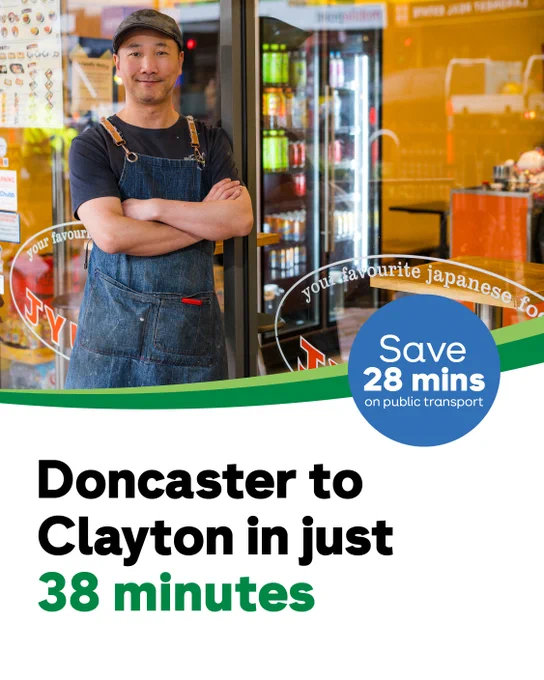 A person in a denim apron stands in front of a Japanese restaurant, smiling with arms crossed. A public transport advertisement reads, "Doncaster to Clayton in just 38 minutes.