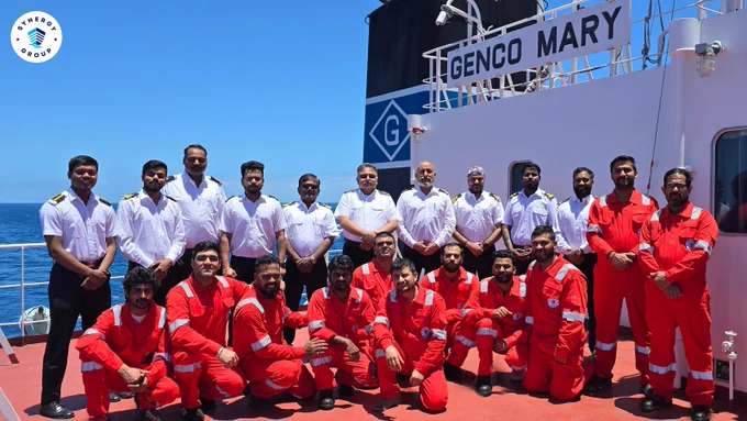 Crew of Ultramax vessel GENCO MARY assembled on deck with officers and crew in safety gear following a successful search and rescue operation at sea