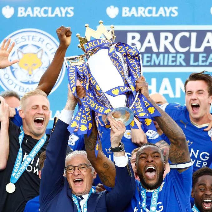 Claudio Ranieri and Wes Morgan lift the Premier League trophy.