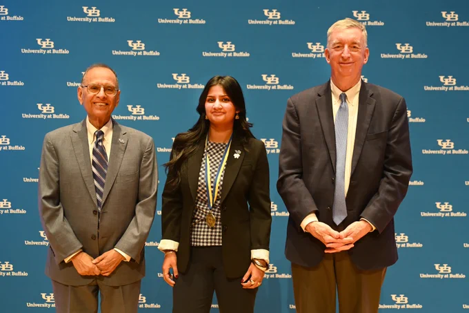 President Tripathi and Provost Weber pose for a picture with a student scholar at the annual Celebration of Student Academic Excellence.