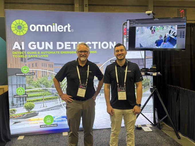 Team members Dan (left) and Joe (right) standing in the Omnilert Booth at the ABA Risk and Compliance Conference. 