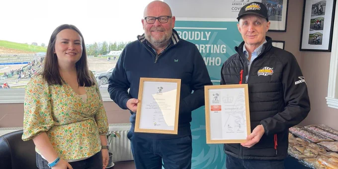 Highland RFCA's Defence Relationship Manager standing next to Rural Skills Scotland staff member holding an Armed Forces Covenant certificate and Knockhill Racing Circuit's Director of Events holding an Employer Recognition Scheme Bronze Award certificate.