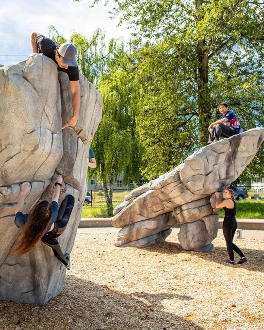 People climbing faux rock structures