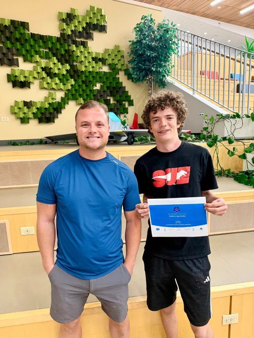 Isaac and his mentor smiles for a photo.