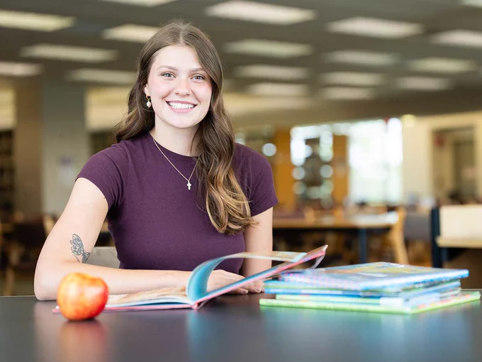 a photo of a student working in a library