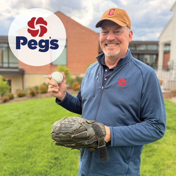 Peg’s Foundation President and CEO Rick Kellar holding a baseball.