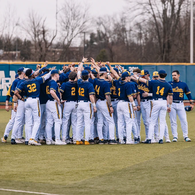 Kent State Universities men's baseball team in a huddle on the field. 
