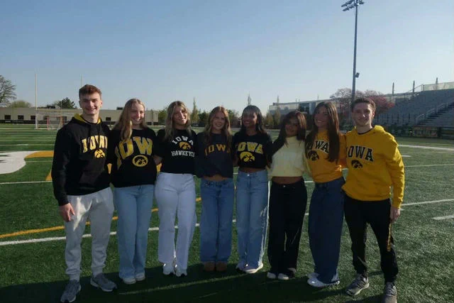 An Iowa gear group photo on a field.
