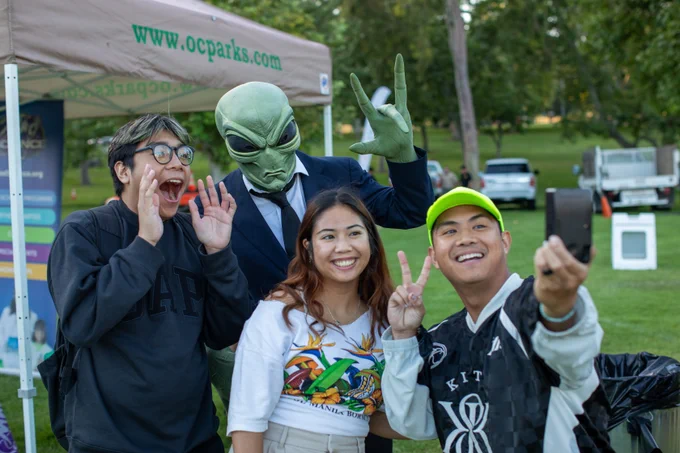Group of people posing with themed movie character.