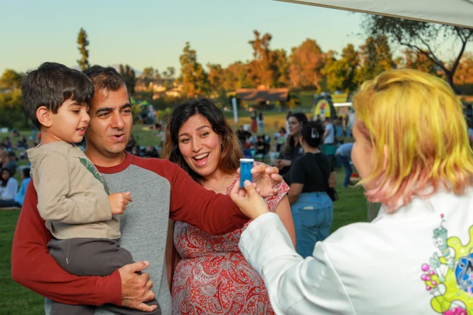 A family posing while doing an activity.
