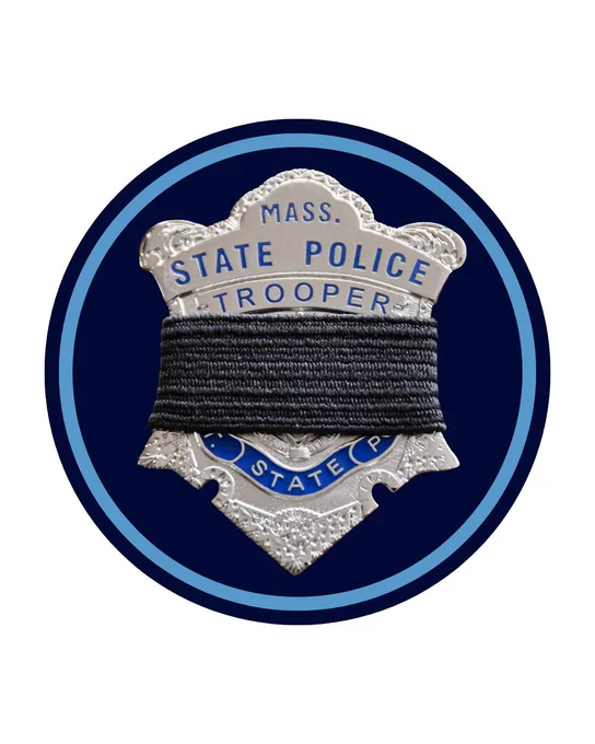 Massachusetts State Police trooper badge wrapped with a black mourning band on a dark blue circular background.
