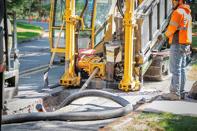 Crews work in a ditch to replace underground cable in Olympia