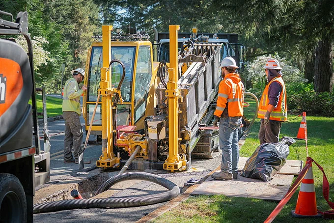 Crews work in a ditch to replace underground cable in Olympia