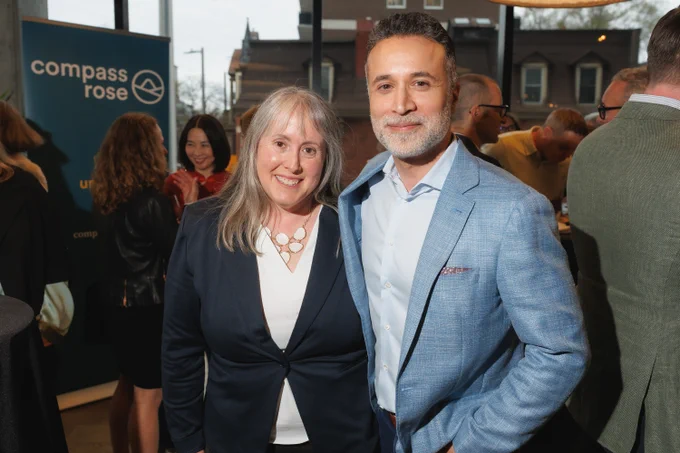 Two people posing for a photo at a reception