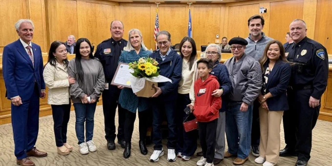 Group photo featuring the person who was saved, along with his family members, Mayor Ron Case, Police Chief Sackett and Fire Chief Gerber