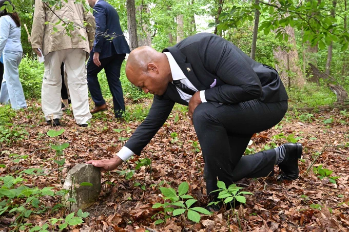 Governor Moore visiting unmarked graves at the House of Reformation in Cheltenham. 

