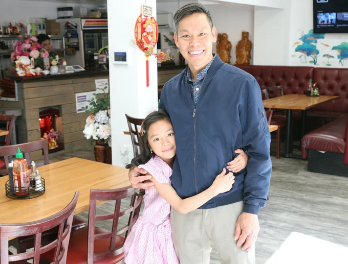 Vu Huynh — shown with his daughter, Emma, inside their restaurant, Huong Que, at 272 Adams St.—plans to open a companion billiards hall next door. Seth Daniel photo
