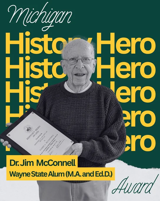 Dr. McConnell stand, holding his HSM History Hero Award