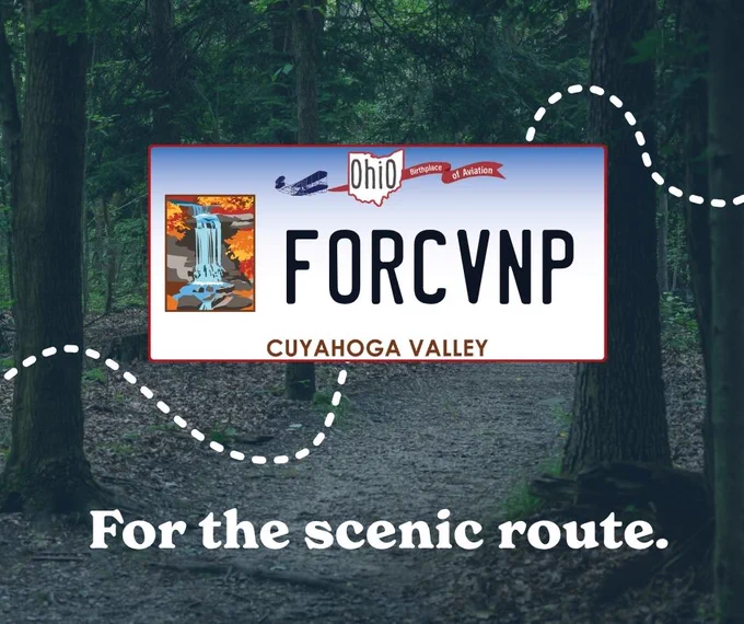 Ohio license plate with 'FORCVNP' and Cuyahoga Valley illustration over a forest trail background.