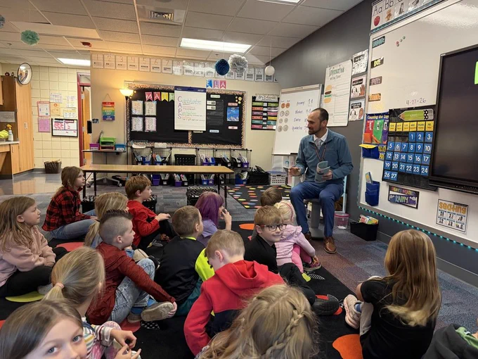 Superintendent Aulie reading to Ms. Esse's class