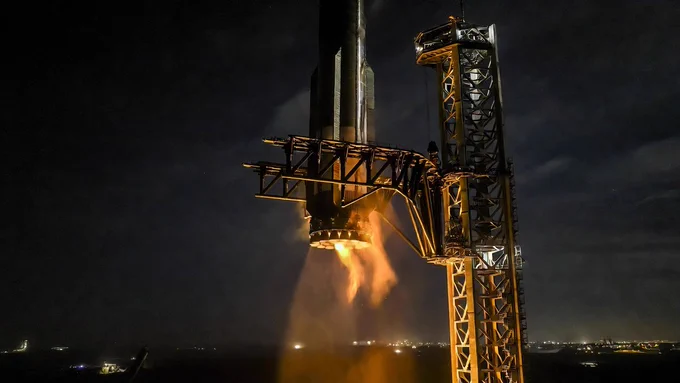 Minimalist professional photograph of Super Heavy V3 booster on the orbital launch mount at dawn, clean dark background with soft natural light, conveying strategic readiness.