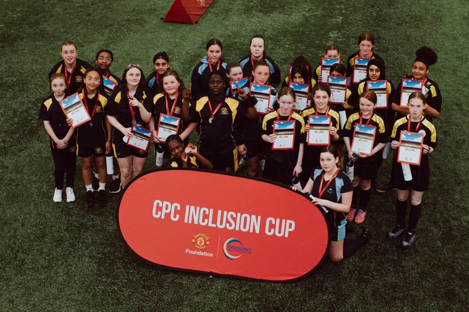 Girls pose with certificates at the Cliff Training Ground