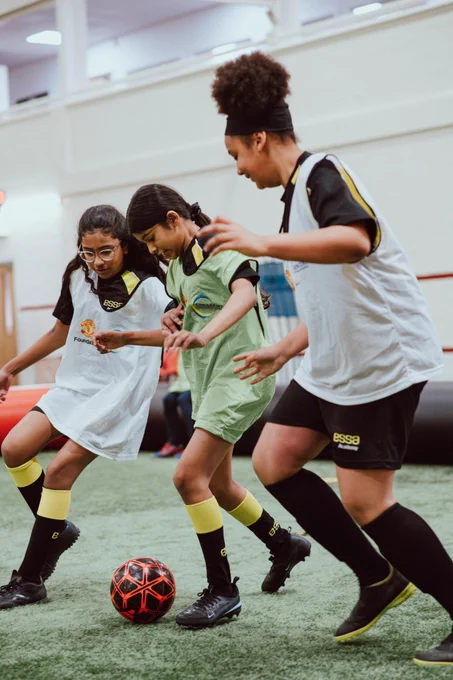 Girls play football at the Cliff Training Ground