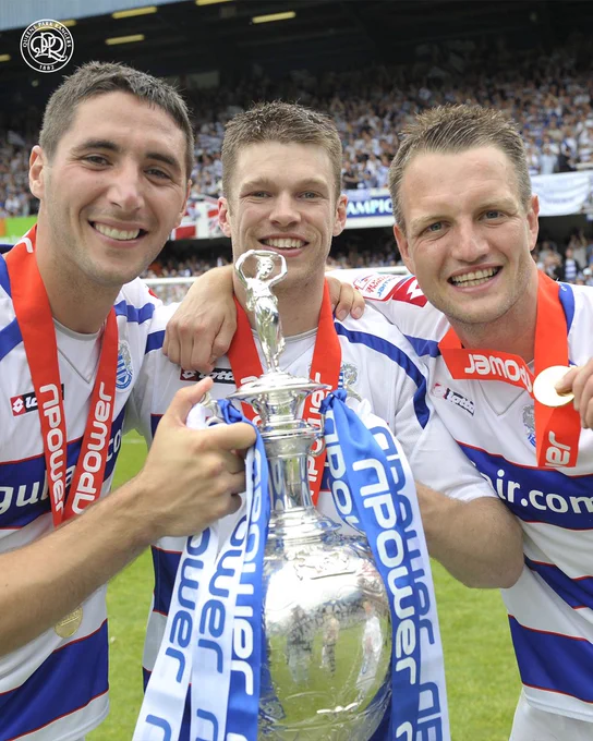 Bradley Orr (left), Jamie Mackie (centre) and Clint Hill (right) celebrating with the Championship trophy.