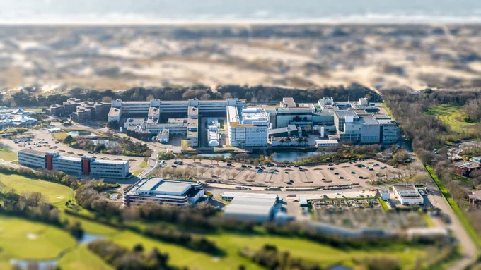 ESA's ESTEC technology centre seen from the air, among coastal sand dunes.