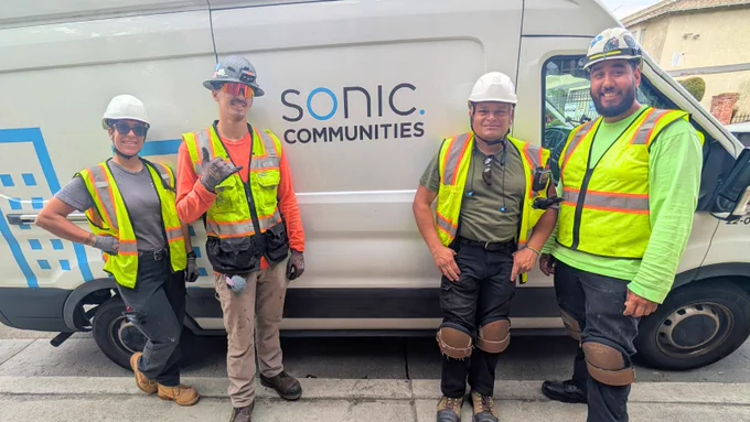 Sonic’s MDU Team posing together and smiling in front of the Sonic Communities Van in Los Angeles County