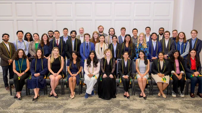 A group photo of top SMU Cox School of Business Information Technology and Operations Management students at the induction ceremony to the Kappa Chapter of Alpha Iota Delta, an international honor society that recognizes undergraduate and graduate students in the top 10 percent of their class.