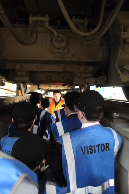 Tom from the Class 507 Preservation Society talks to a group of students in the pit underneath 507001.